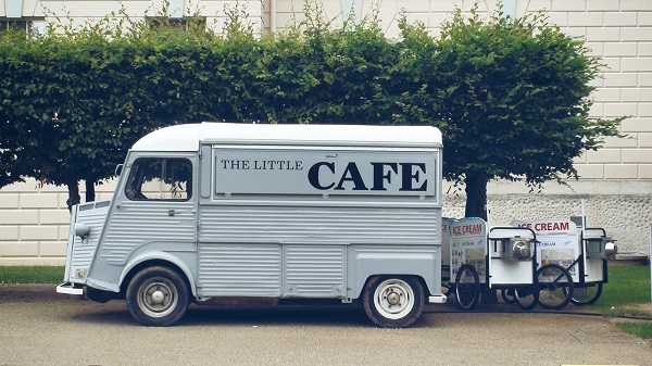 Picture of a grey food truck with ice cream carts behind it